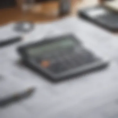 Calculator and house plans on a desk